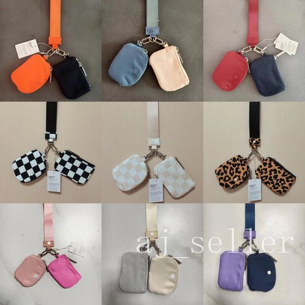 Compact wristlet clutch with dual pouches, detachable keychain, and mini zip-around wallet for coins and essentials