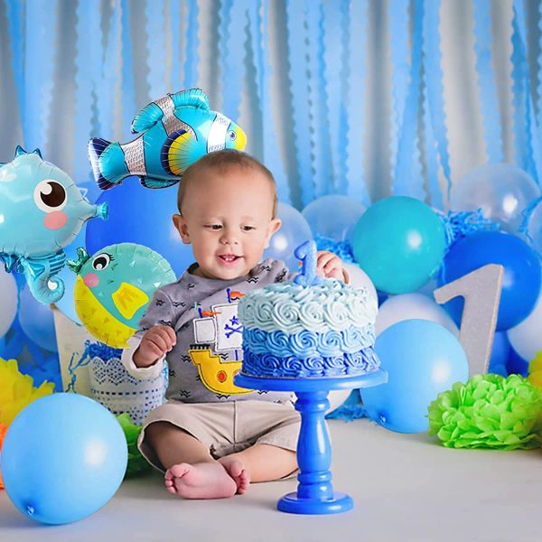 Ocean-themed birthday decorations with a balloon arch kit for an under-the-sea party featuring animal foil balloons and party supplies
