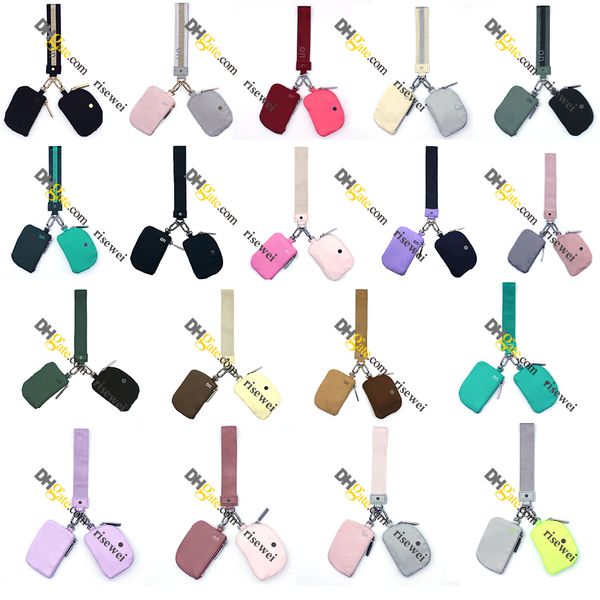 Pink dual-compartment wristlet wallet for women with keychain, featuring a mini zippered coin purse and compact design