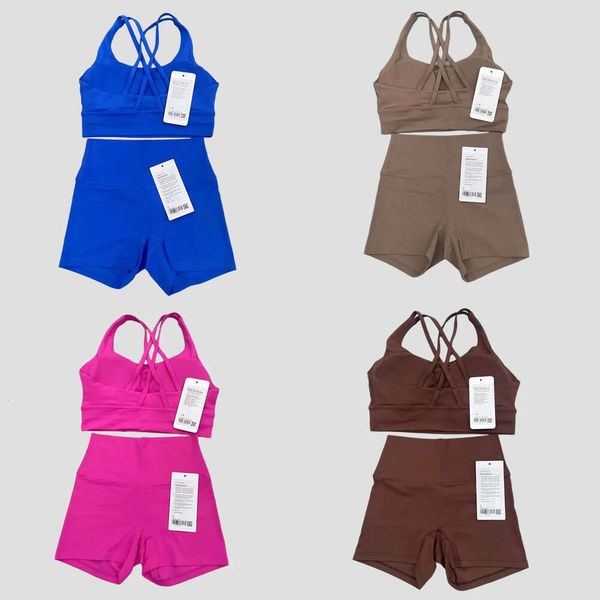 Two-piece women's yoga set featuring a back-cross sports bra, fitness tank top, and high-waisted workout biker shorts