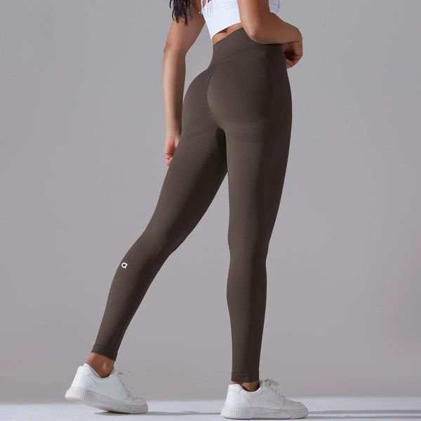 Women's athletic leggings for running, featuring a snug fit, high waist, and solid brown knitted fabric, ideal for yoga and sports
