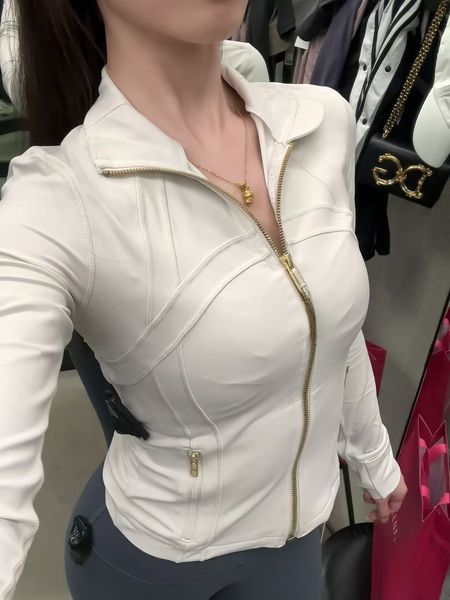 Women's cropped workout jacket with gold zipper, long sleeves for gym and activewear