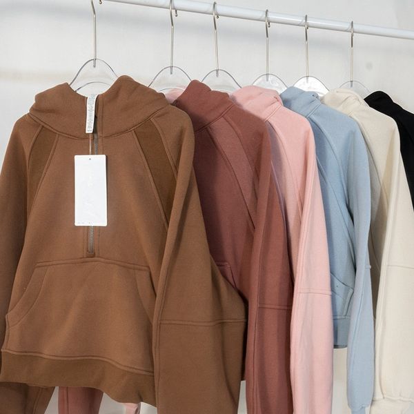 Women's fleece hoodie jacket with half-zip, long sleeves, pockets, and thumbholes
