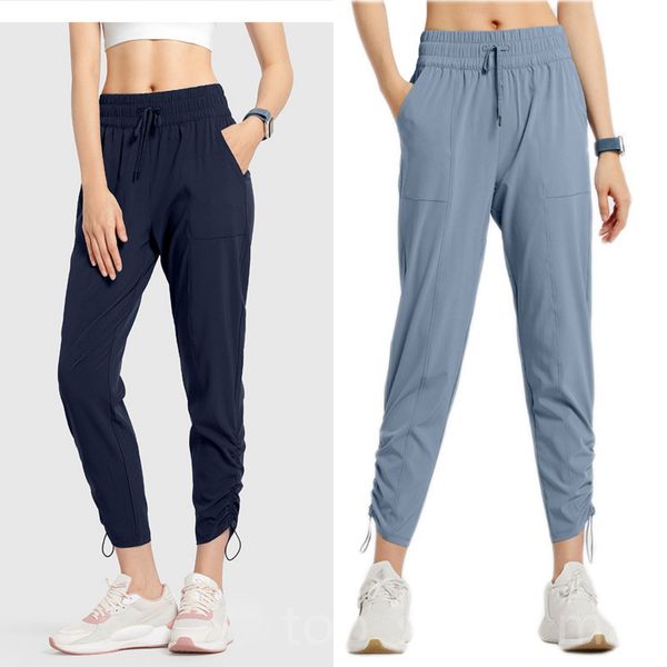 Women's loose-fit sweatpants with drawstring waist, side pockets, and tapered legs for running, gym, and training