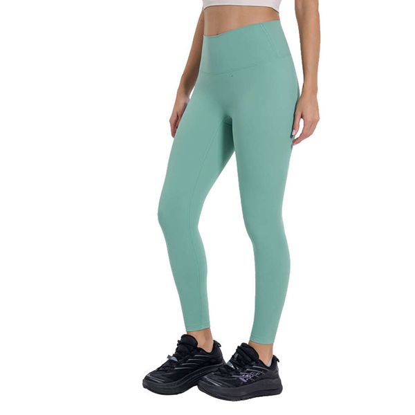 Women's solid color high-waisted yoga leggings with elastic fit for gym workouts and sports, made from soft nude material