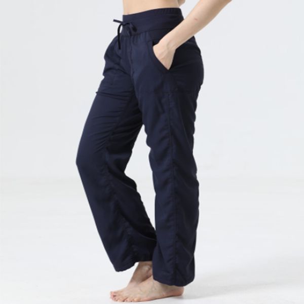 Women's stretchy full-length yoga pants with wide legs, pockets, and 4-way flexibility for workouts and running