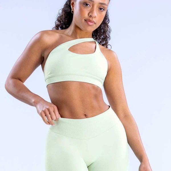 Yoga top with diagonal straps for high-impact workouts, backless design offers support without seams